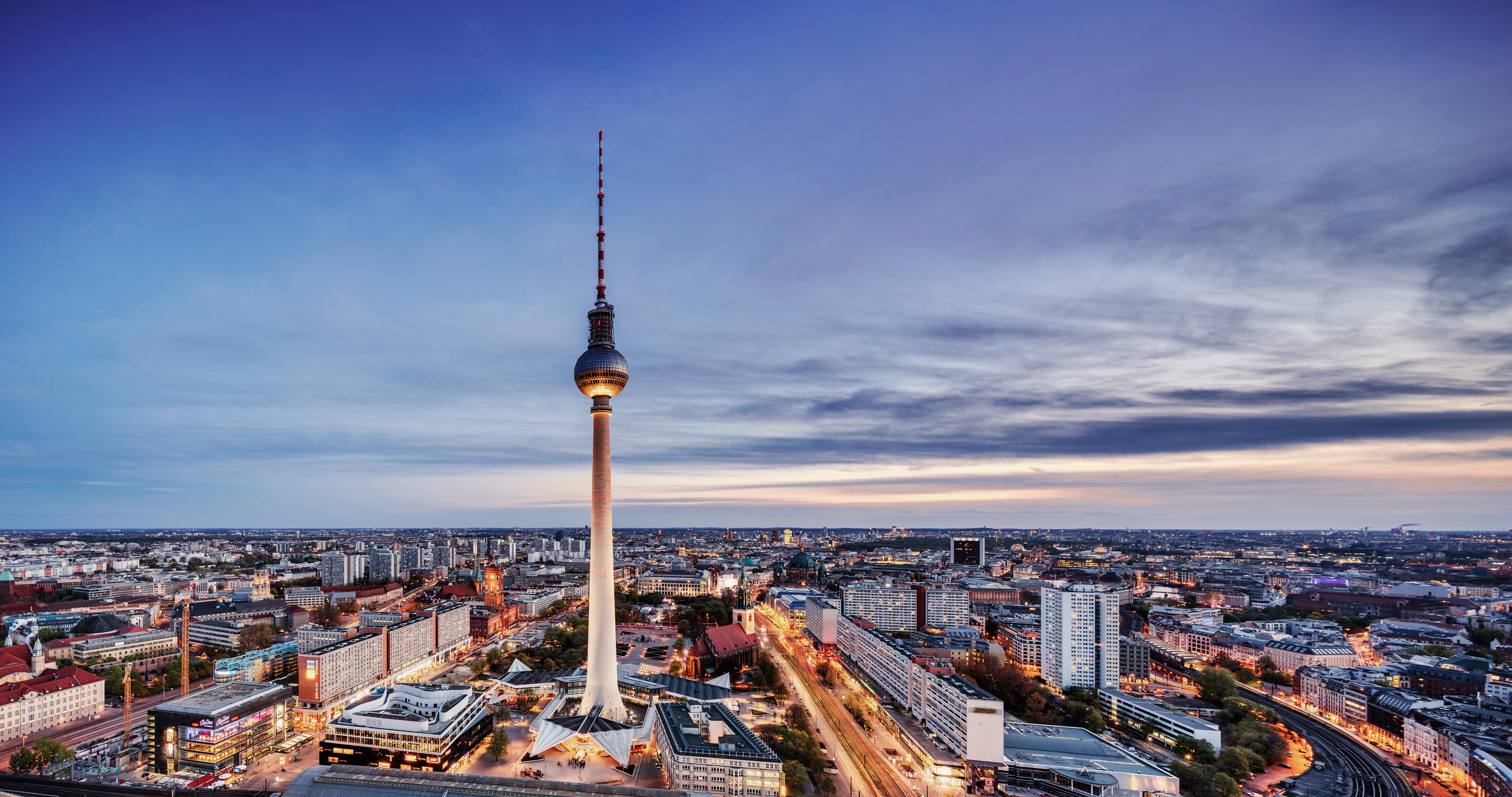 Berlin TV Tower at dusk with a view over the city.