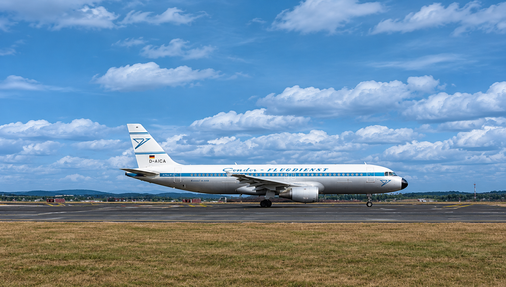 Condor aircraft in historic livery on the taxiway in front of a cloudy sky.
