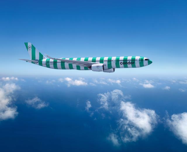 A passenger aircraft, shown from the side, in a green-and-white striped livery, flying above the clouds.